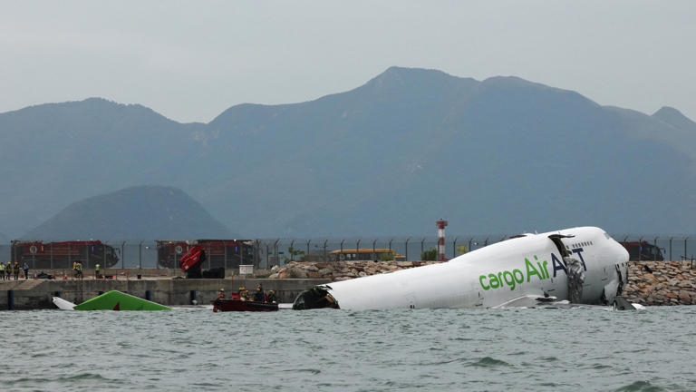 Cargo plane skids off Hong Kong runway,...